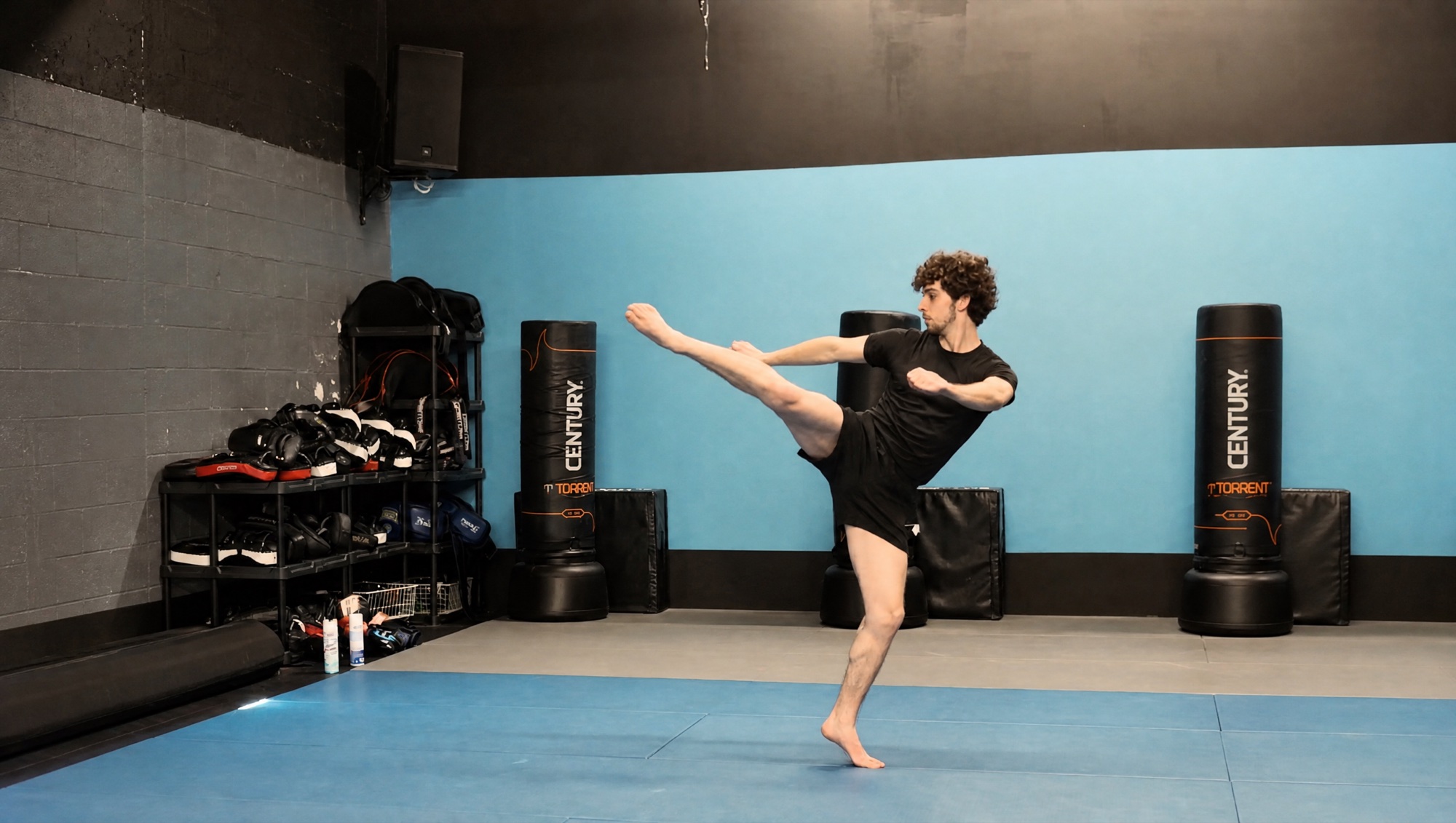 Charlie Wilson throwing a high kick on the training mats